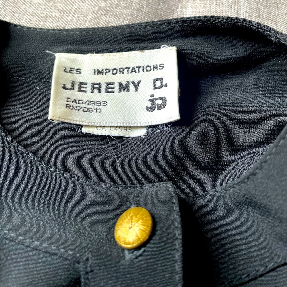 Bomber jacket. Brown and black. Rayon and polyester blend. Fitted.